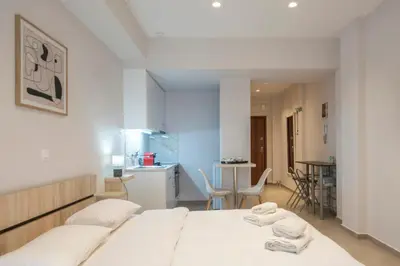 a bedroom with a bed with two towels on it at Koukaki Sofia's Apartment in Athens