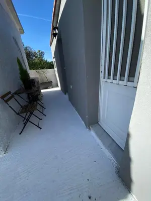 a pair of chairs sitting next to a door at Fanis Rooms in Aghia Marina