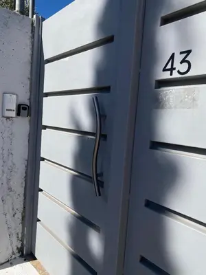 a metal garage door with the number on it at Fanis Rooms in Aghia Marina