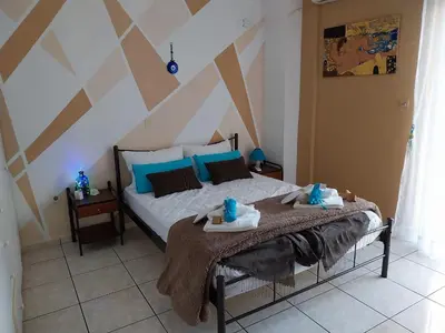 a bedroom with a bed with towels on it at LEONEG corner in Athens