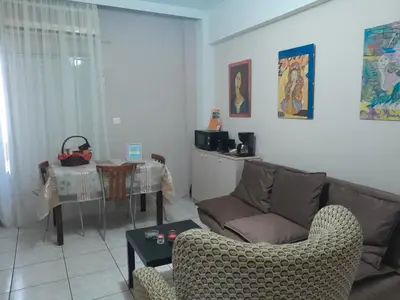a living room with a couch and a table at LEONEG corner in Athens