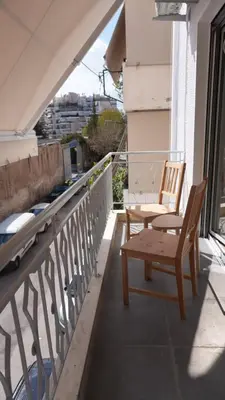 a pair of chairs sitting on a balcony at Harmony Twin Lofts Metaxourgeio 1 in Athens