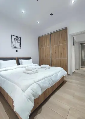 a large bed with a wooden headboard in a bedroom at Harmony Twin Lofts Metaxourgeio 1 in Athens