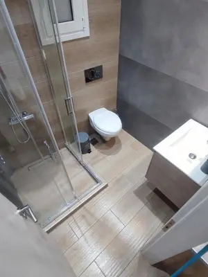 a bathroom with a shower and a toilet and a sink at Harmony Twin Lofts Metaxourgeio 1 in Athens