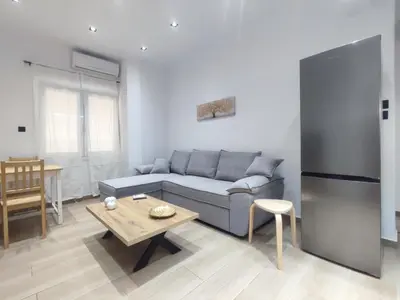 a living room with a couch and a table at Harmony Twin Lofts Metaxourgeio 1 in Athens