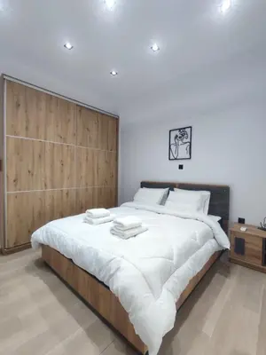 a bedroom with a large bed with a wooden headboard at Harmony Twin Lofts Metaxourgeio 2 in Athens