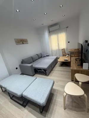 a living room with a couch and a table at Harmony Twin Lofts Metaxourgeio 2 in Athens