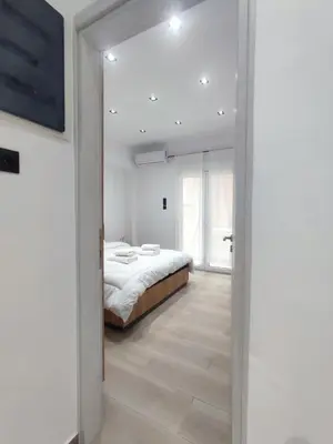 a bedroom with a bed and a large mirror at Harmony Twin Lofts Metaxourgeio 2 in Athens