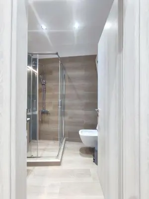 a bathroom with a shower and a toilet and a sink at Harmony Twin Lofts Metaxourgeio 2 in Athens
