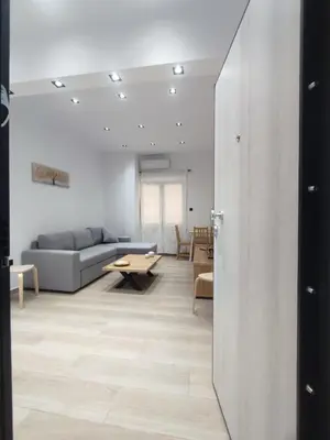 a living room with a couch and a table at Harmony Twin Lofts Metaxourgeio 2 in Athens