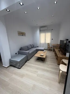 a living room with a couch and a table at Harmony Twin Lofts Metaxourgeio 2 in Athens