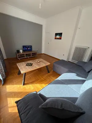 a living room with two couches and a coffee table at Acropolis Harmony Loft in Athens