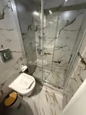 a bathroom with a toilet and a glass shower at Acropolis Harmony Loft in Athens