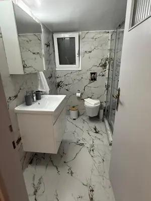 a white bathroom with a sink and a toilet at Acropolis Harmony Loft in Athens