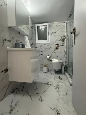 a white bathroom with a sink and a toilet at Acropolis Harmony Loft in Athens