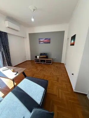 a living room with a couch and a table at Acropolis Harmony Loft in Athens