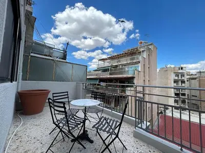 a balcony with two chairs and a table on a balcony at zen- open space in Athens