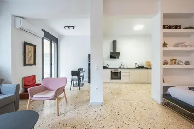 a living room with a bed and a kitchen at zen- open space in Athens