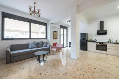 a living room with a couch and a kitchen at zen- open space in Athens