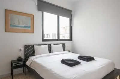 a bedroom with a bed with two towels on it at Zen Spacious, Psirri in Athens