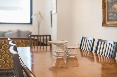 a wooden table with two cups on top of it at Zen Spacious, Psirri in Athens