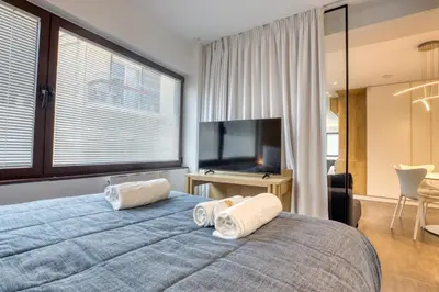 a bedroom with a large bed with two pillows on it at GSM Elevated Luxury Suites in Athens