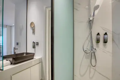 a bathroom with a sink and a shower at GSM Elevated Luxury Suites in Athens