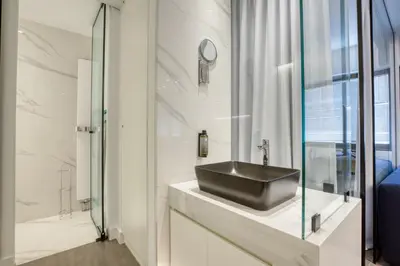 a bathroom with a black sink and a shower at GSM Elevated Luxury Suites in Athens