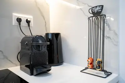 a coffeemaker and a coffee maker on a counter at Stylish apartment at Exarchia in Athens