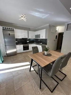 a kitchen with a table and chairs and a refrigerator at Kosmos luxury apartment in Athens