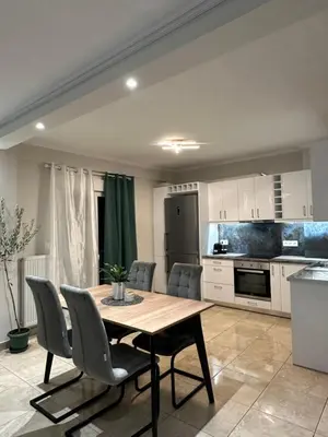 a kitchen and dining room with a table and chairs at Kosmos luxury apartment in Athens