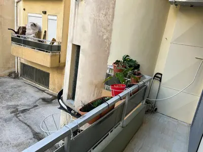 an empty balcony with plants on a building at Cozy apartment in Athens in Athens