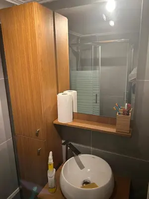 a bathroom with a sink and a mirror at Cozy apartment in Athens in Athens