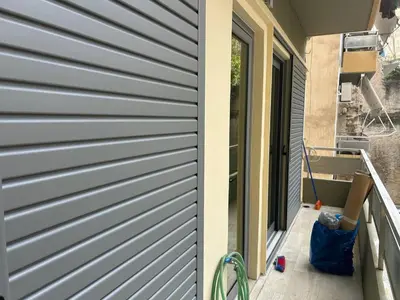 a side view of a house with a door at Cozy apartment in Athens in Athens
