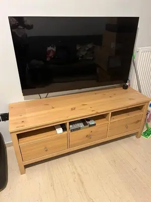 a wooden entertainment center with a flat screen tv on top at Cozy apartment in Athens in Athens