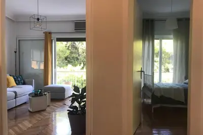 a living room with a couch and a bed at Central flat in Pagrati in Athens