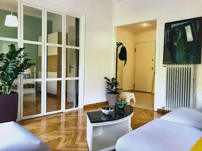 a living room with a couch and a table at Central flat in Pagrati in Athens