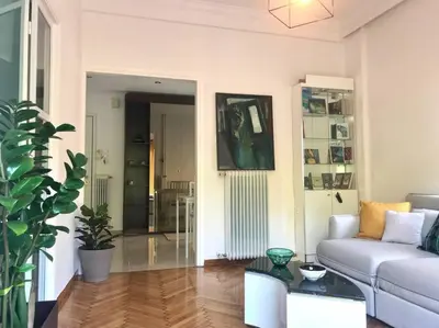 a living room with a couch and a table at Central flat in Pagrati in Athens