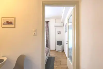 a hallway with a room with a bed and a mirror at Your perfect choice for stay in Athens in Athens