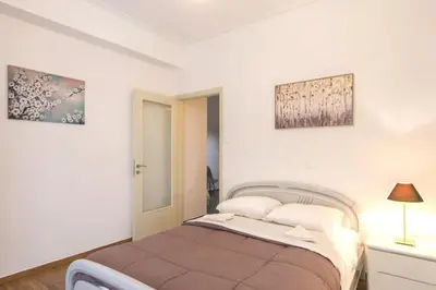 a bedroom with a bed and two pictures on the wall at Your perfect choice for stay in Athens in Athens