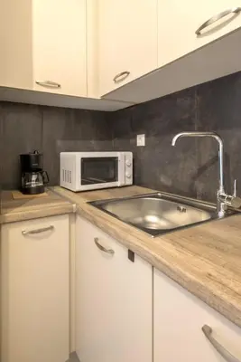 a kitchen with a sink and a microwave at Your perfect choice for stay in Athens in Athens