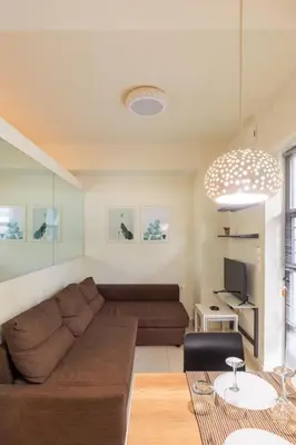 a living room with a couch and a television at AIOLOS glyfada centre apartment 1 in Athens