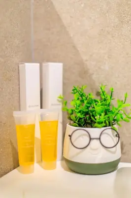 a table with two glasses and a potted plant at AIOLOS glyfada centre apartment 1 in Athens