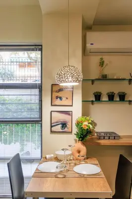 a dining room with a wooden table and chairs at AIOLOS glyfada centre apartment 1 in Athens