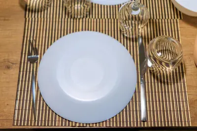 a white plate on a table with a fork and knife at AIOLOS glyfada centre apartment 1 in Athens