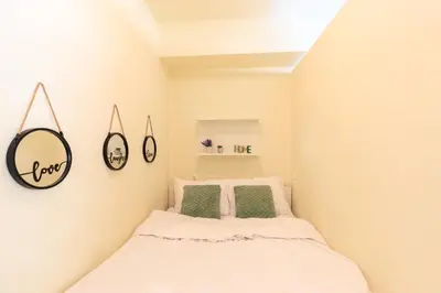a small bedroom with a bed and a mirror at AIOLOS glyfada centre apartment 1 in Athens
