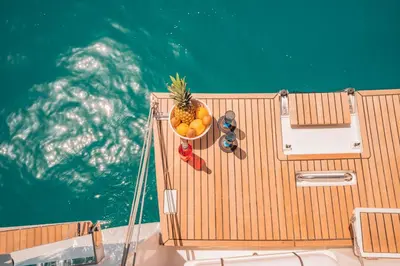 a bowl of fruit and a pineapple on a boat at Luxury Sailing Cruises in Athens with Traditional Greek Cuisine and Drinks in Athens