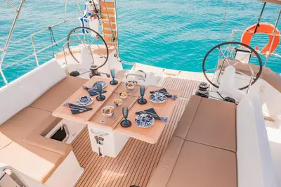 a table on the deck of a boat in the water at Luxury Sailing Cruises in Athens with Traditional Greek Cuisine and Drinks in Athens