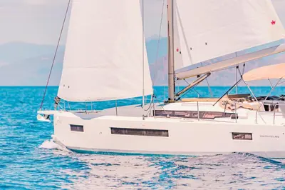 a white sailboat on the water in the ocean at Luxury Sailing Cruises in Athens with Traditional Greek Cuisine and Drinks in Athens