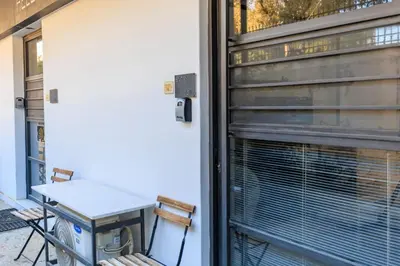 a window with a table and chairs on a patio at AIOLOS glyfada centre apartment 2 in Athens